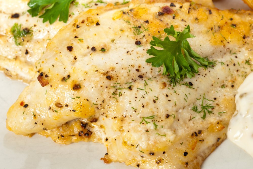 Close up of baked fish fillet with herbs