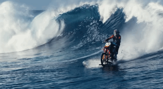 Daredevil riding motorcycle on wave Daredevil riding motorcycle on wave