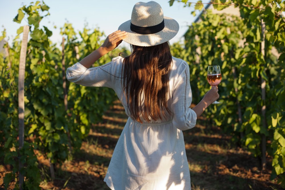 Woman enjoying fine wine at a vineyard Woman enjoying fine wine at a vineyard