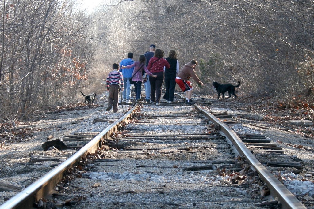 Family on a walk together on railroad tracks Family on a walk together on railroad tracks