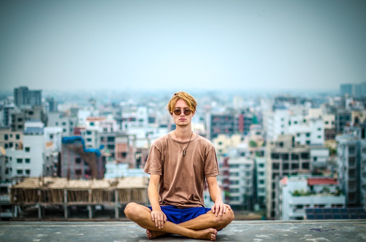 Man doing yoga in urban setting Man doing yoga in urban setting