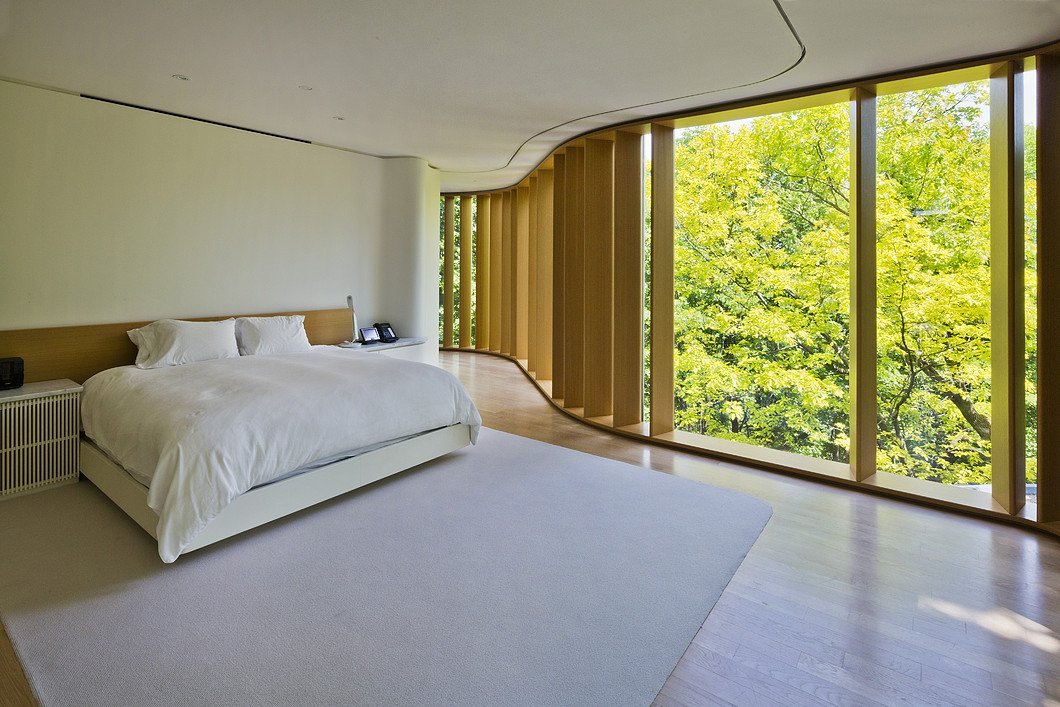 Floor to ceiling curved windows in bedroom Floor to ceiling curved windows in bedroom