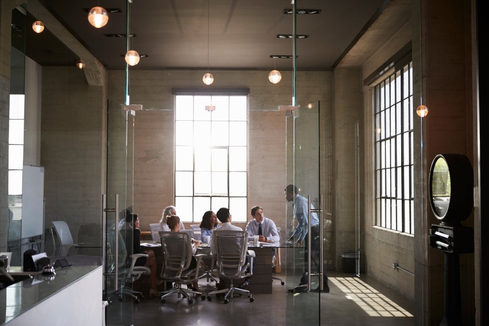 Business colleagues at a meeting in a glass walled boardroom Business colleagues at a meeting in a glass walled boardroom