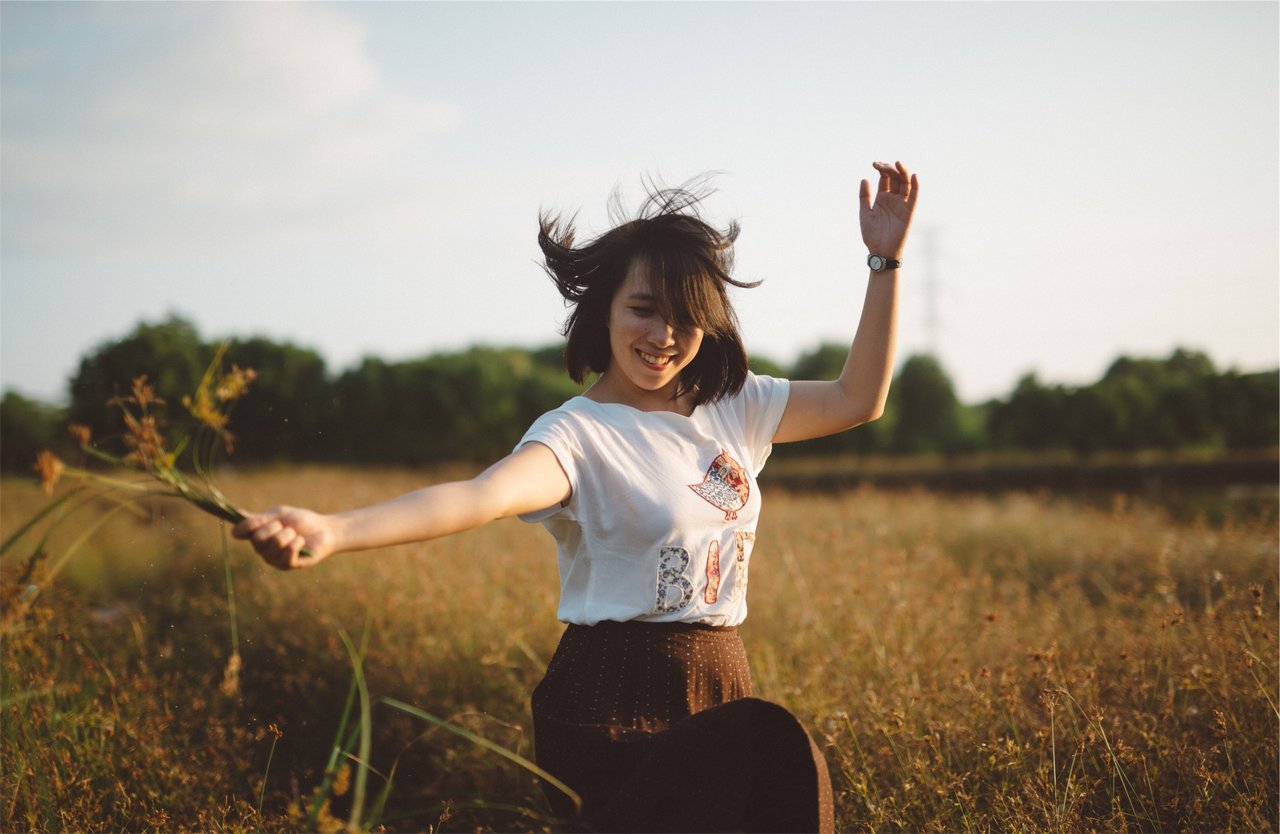 teen smiling in field teen smiling in field