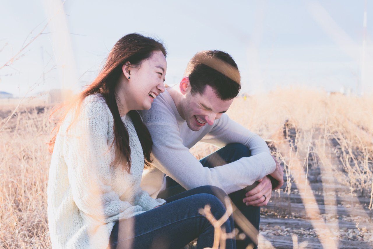 happy teens laughing in field happy teens laughing in field