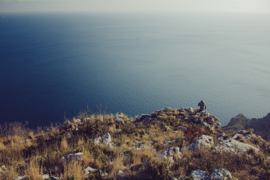 Man alone on cliffs Man alone on cliffs