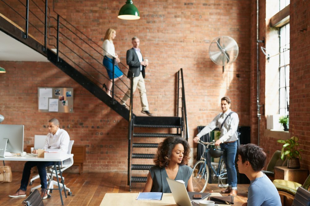Start of a busy day at work in trendy office with business people Start of a busy day at work in trendy office with business people