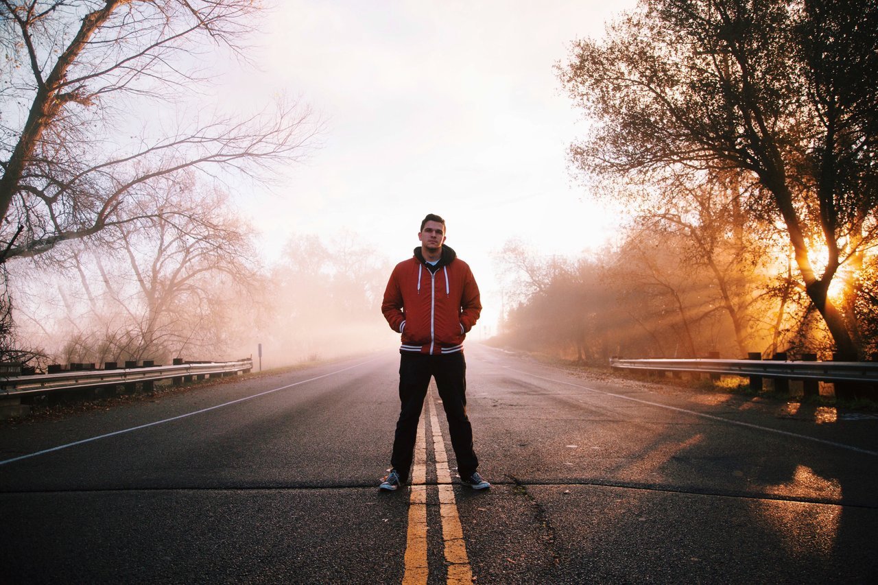 teen standing in middle of road teen standing in middle of road