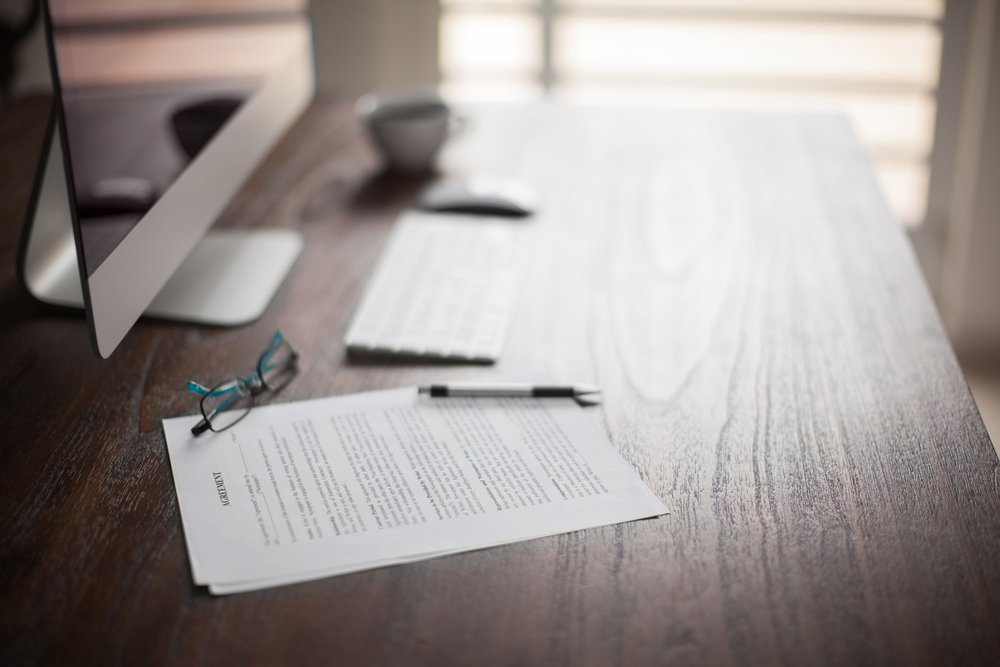 contracts and pen on table contracts and pen on table