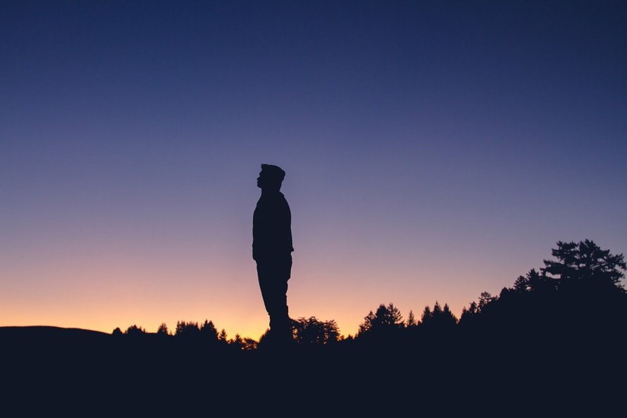 Person silhouetted against sunset Person silhouetted against sunset
