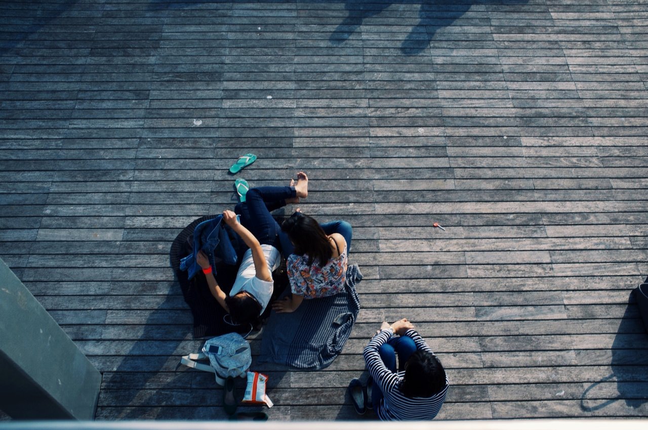 One girl left out of a group of friends One girl left out of a group of friends