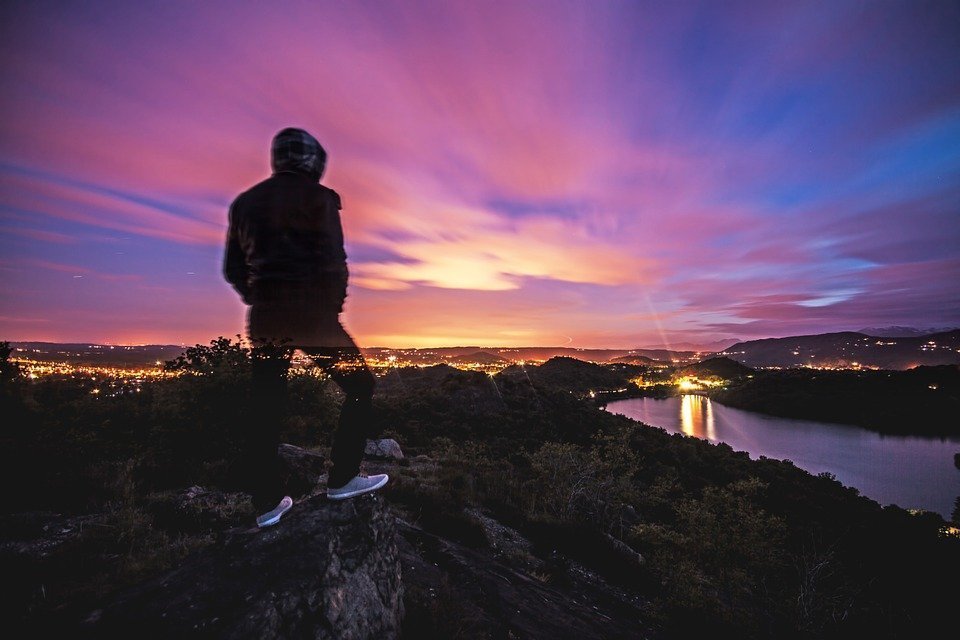 Teen overlooking a city at sunset Teen overlooking a city at sunset