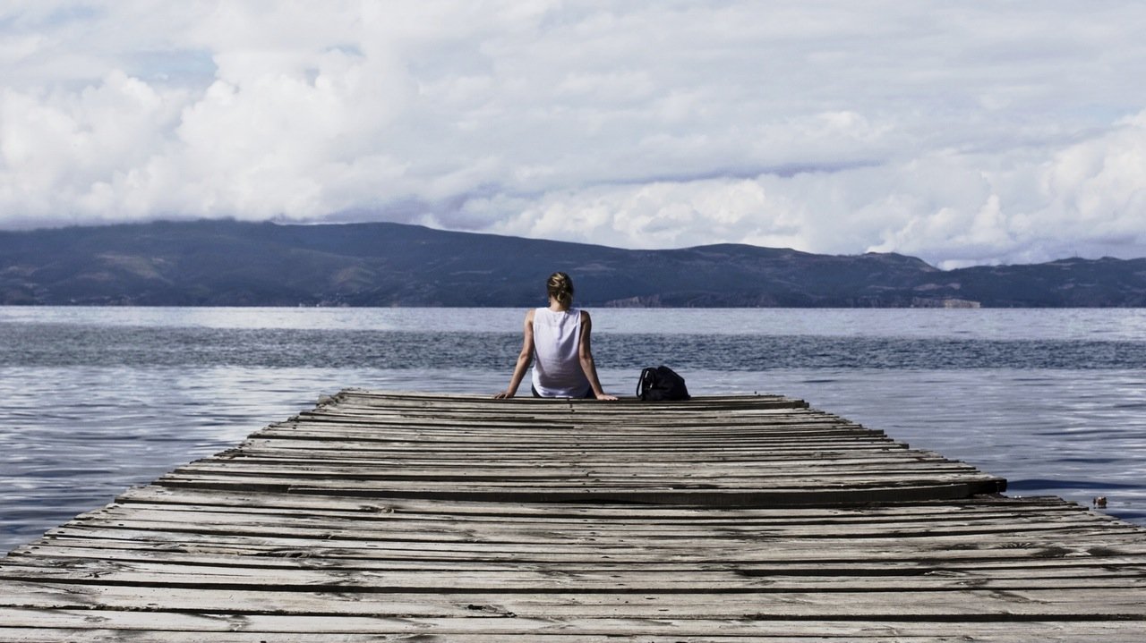 teen sitting on a pier teen sitting on a pier