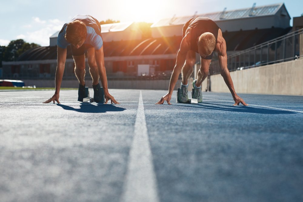 Two runners on the start line of a track Two runners on the start line of a track