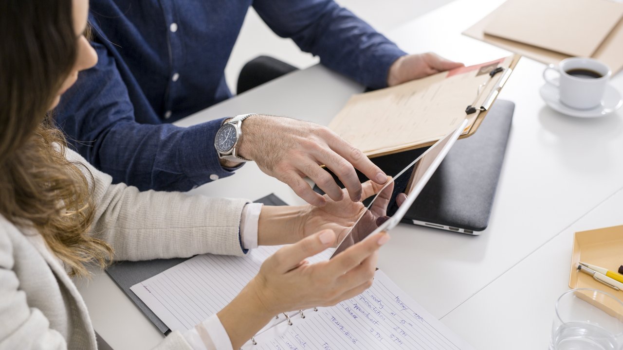 People look at iPad with data People look at iPad with data