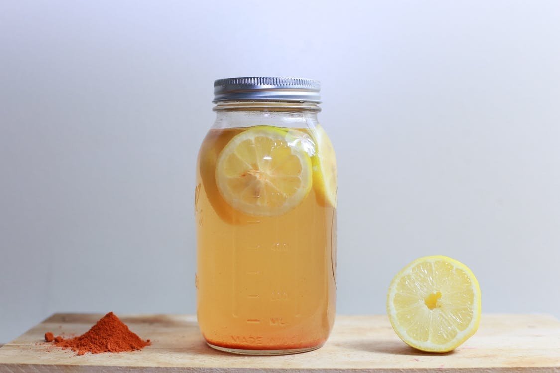 Glass jar with lemon cayenne water Glass jar with lemon cayenne water