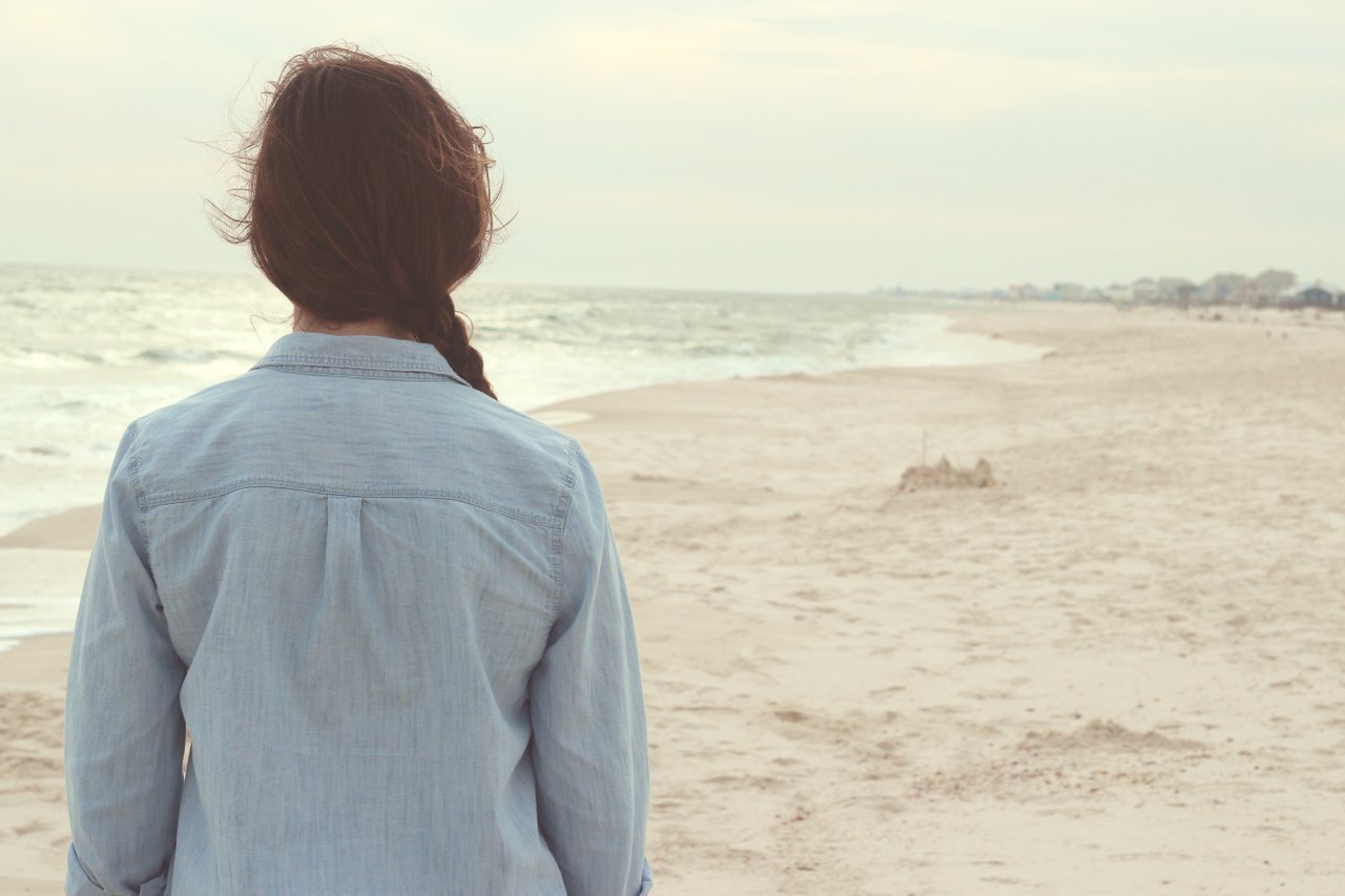 Woman on the seashore looking out Woman on the seashore looking out