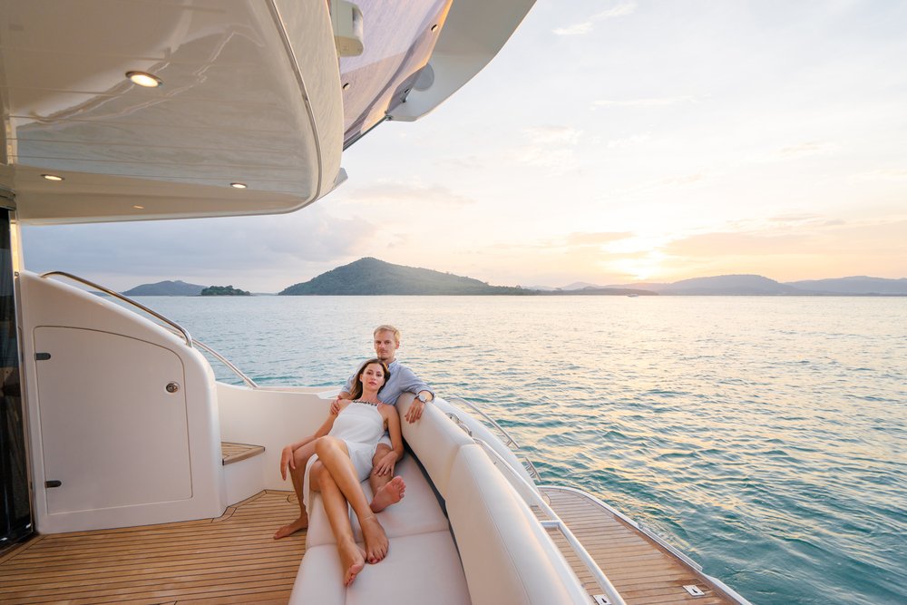 Young Couple Sitting Together on Yacht Young Couple Sitting Together on Yacht